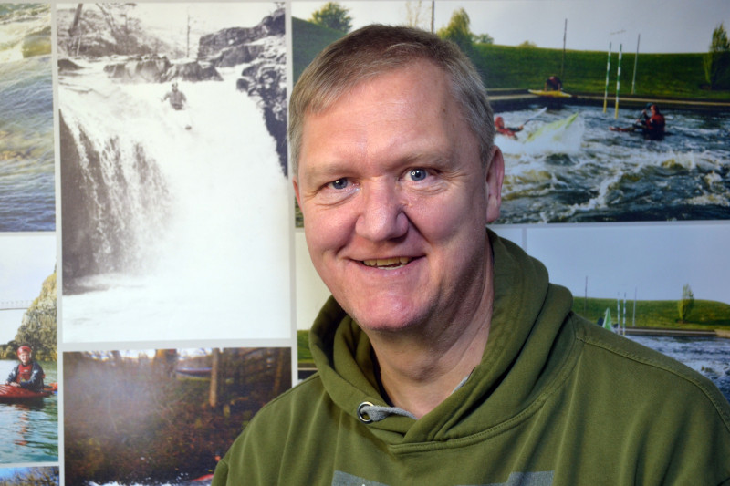 Dave standing in front of his own kayak photos